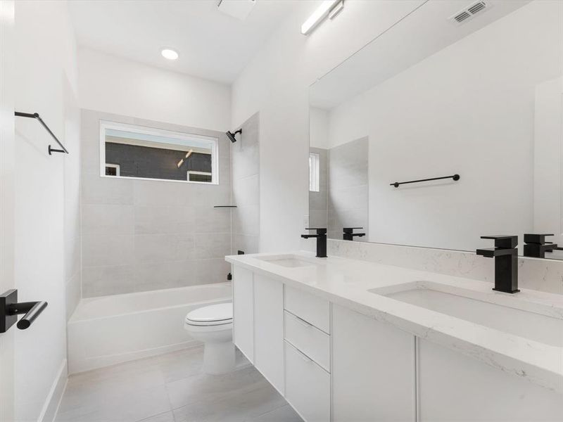 Bathroom 4 with tub / shower combination and light tile patterned flooring