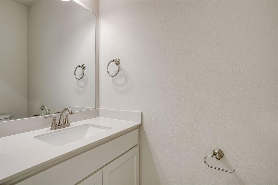 Bathroom featuring vanity and toilet