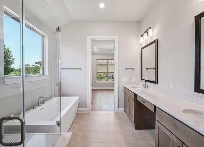 Full bath with a soaking tub, double vanity, recessed lighting, and tile patterned flooring
