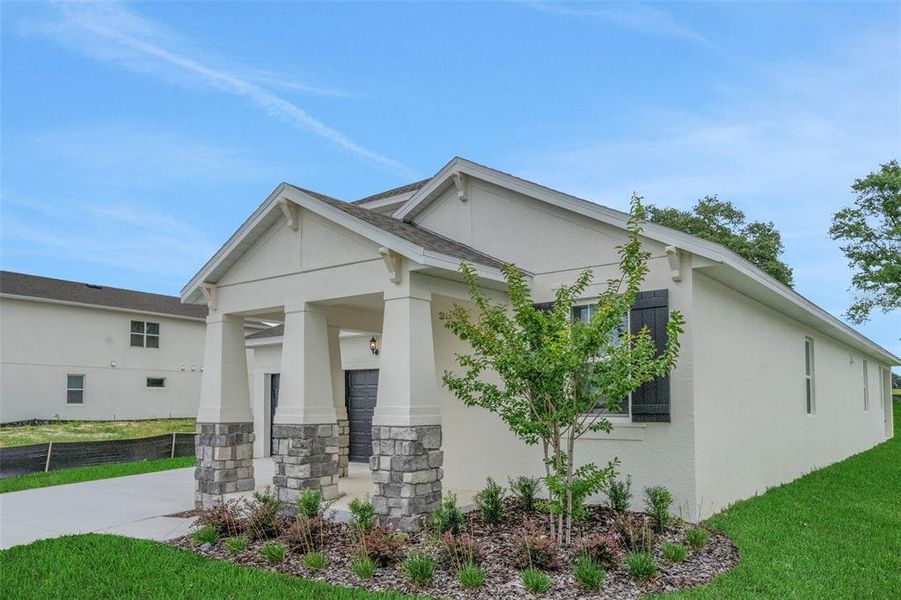 Front exterior of a new home in Crossroads at Kelly Park, Apopka, FL, highlighting curb appeal (Image 20). Front exterior of a new home in Crossroads at Kelly Park, Apopka, FL, highlighting curb appeal (Image 20).