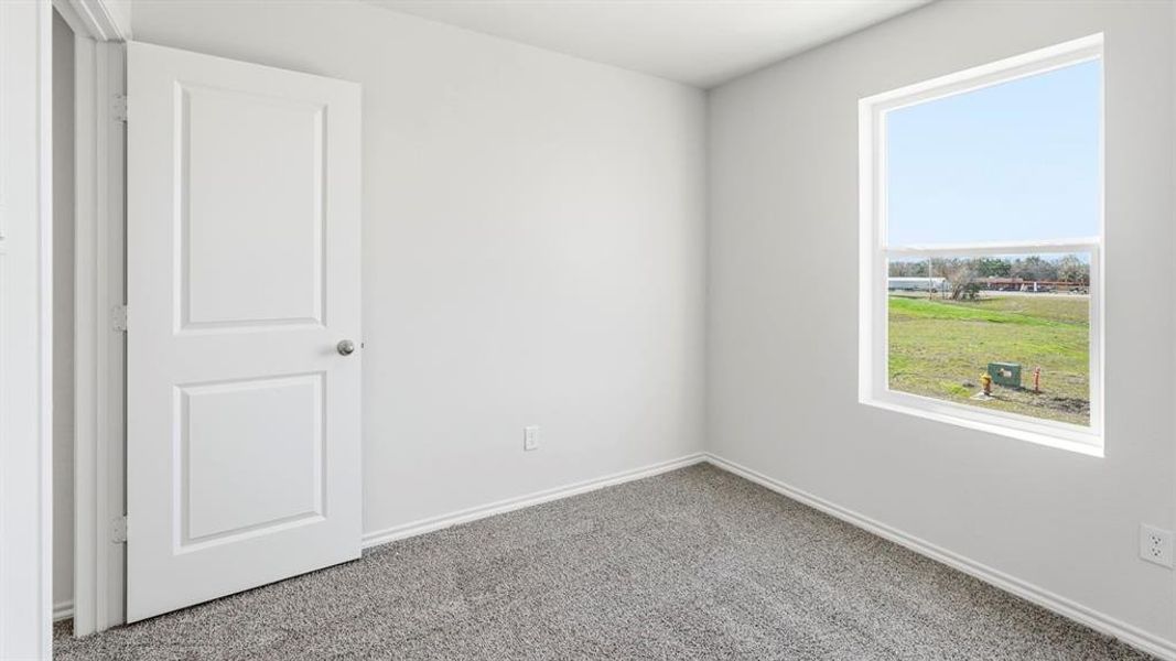 Unfurnished room featuring carpet and baseboards
