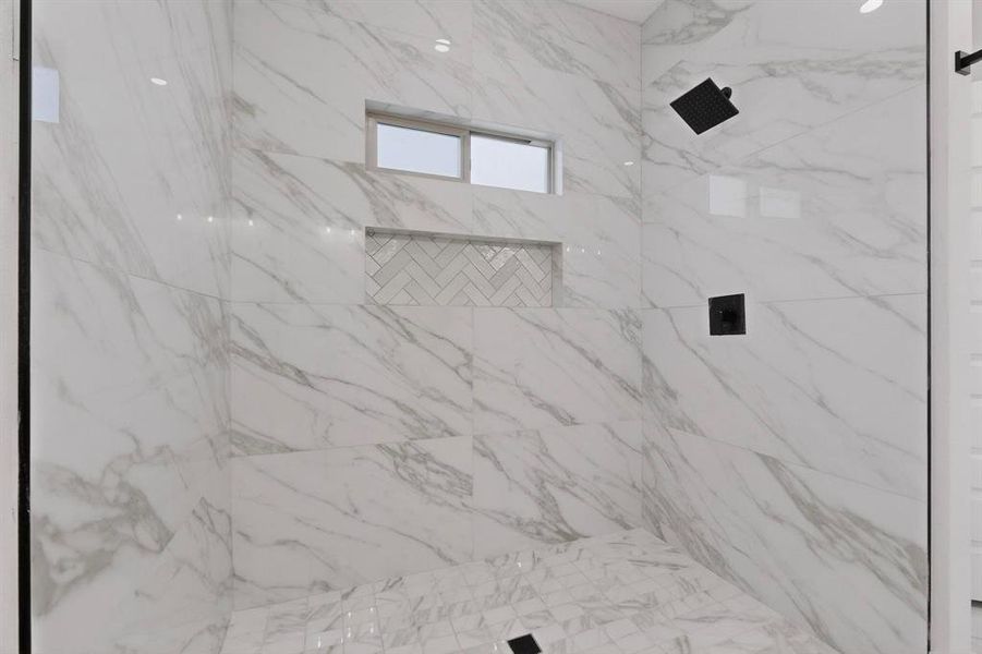 Bathroom with a marble finish shower