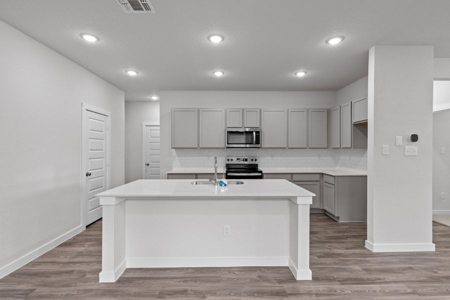 A kitchen with white cabinets. A kitchen with white cabinets.