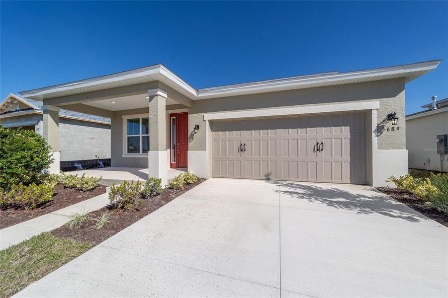 Front exterior of a new home in Calesa Township, Ocala, FL, highlighting curb appeal (Image 22).