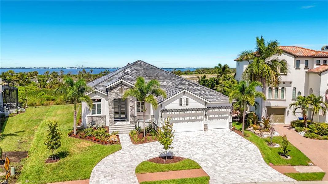 Front exterior of a new home in Legends Bay, Bradenton, FL, highlighting curb appeal (Image 22). Front exterior of a new home in Legends Bay, Bradenton, FL, highlighting curb appeal (Image 22).