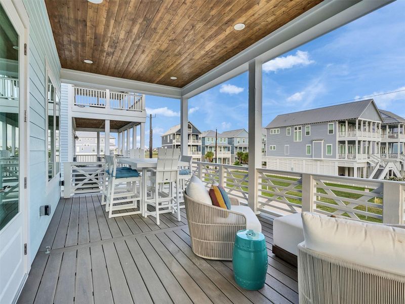 Feel the essence of coastal living in this expansive porch just outside the living/dining/kitchen combo. Gentle Gulf breezes, protected views, and the soft sway of hanging chairs invite calm and serenity. Morning coffee, sunset cocktails, or quiet evenings are enhanced by music streaming through internet-connected Sonos Amps, creating the perfect soundtrack. Here, relaxation meets connection, and beachside living becomes a lifestyle of effortless joy and elegance. Feel the essence of coastal living in this expansive porch just outside the living/dining/kitchen combo. Gentle Gulf breezes, protected views, and the soft sway of hanging chairs invite calm and serenity. Morning coffee, sunset cocktails, or quiet evenings are enhanced by music streaming through internet-connected Sonos Amps, creating the perfect soundtrack. Here, relaxation meets connection, and beachside living becomes a lifestyle of effortless joy and elegance.