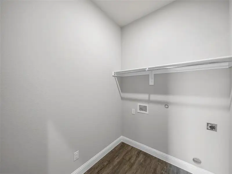 Laundry area with laundry area, hookup for a washing machine, hookup for an electric dryer, dark wood-style flooring, and baseboards Laundry area with laundry area, hookup for a washing machine, hookup for an electric dryer, dark wood-style flooring, and baseboards