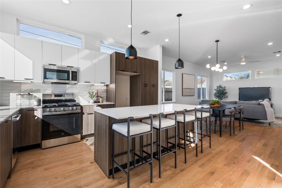 Open-concept layout seamlessly connecting the kitchen, dining & living areas, perfect for everyday living or entertaining guests, all enhanced by warm natural light. Open-concept layout seamlessly connecting the kitchen, dining & living areas, perfect for everyday living or entertaining guests, all enhanced by warm natural light.