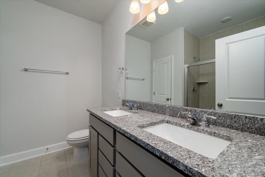 The Owner's Bathroom features dual-vanity sinks, a shower, and water closet. The Owner's Bathroom features dual-vanity sinks, a shower, and water closet.