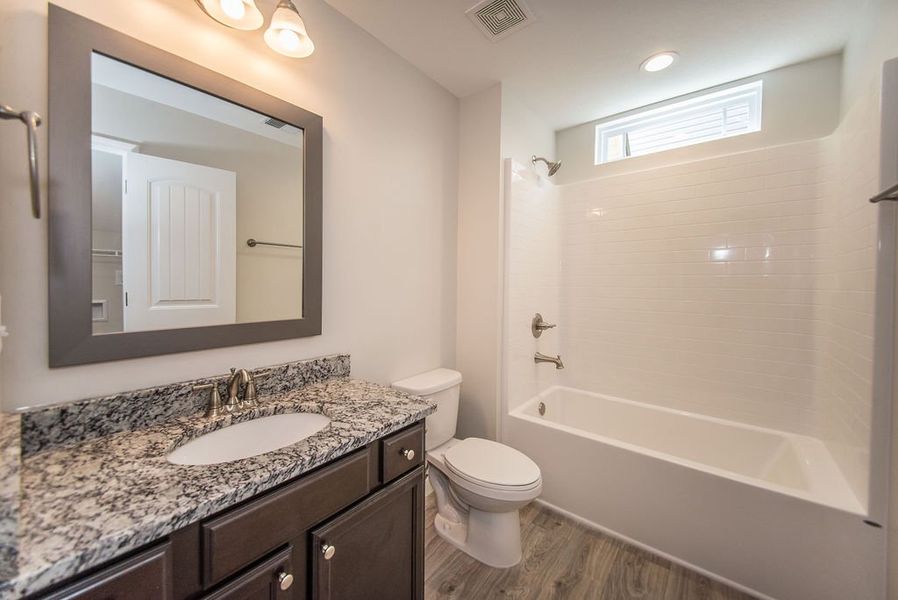 Representative furnished interior of a home built from the Quincy by Enchanted Homes in Hampshire Heights, Moore (Image 8).