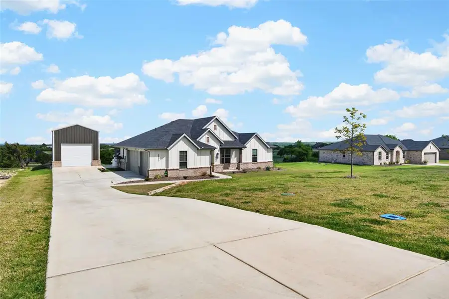 Front exterior of a new home in Gatlin Ranch, Springtown, TX, highlighting curb appeal (Image 22).
