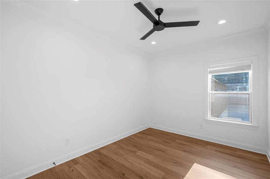 Unfurnished room featuring wood finished floors, crown molding, ceiling fan, and recessed lighting Unfurnished room featuring wood finished floors, crown molding, ceiling fan, and recessed lighting