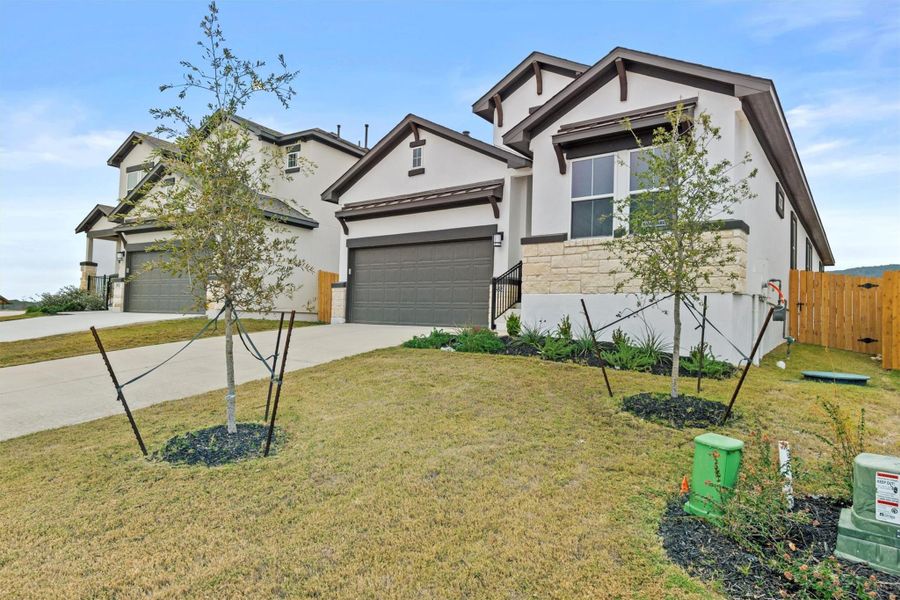 View of front facade with a front yard and a garage