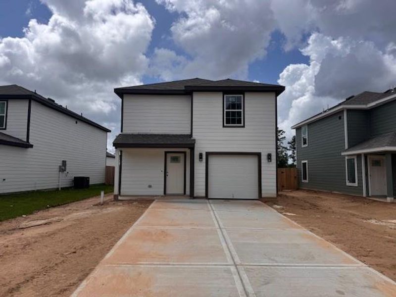 Front exterior of a new home in Townsend Reserve, Splendora, TX, highlighting curb appeal (Image 1). Front exterior of a new home in Townsend Reserve, Splendora, TX, highlighting curb appeal (Image 1).