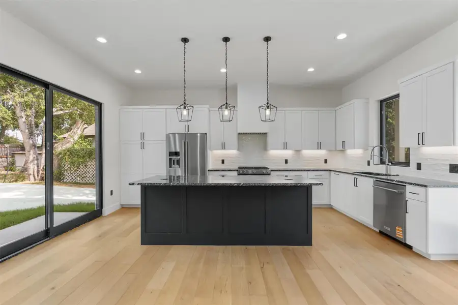 Kitchen island equipped with pop up outlets and cell phone chargers