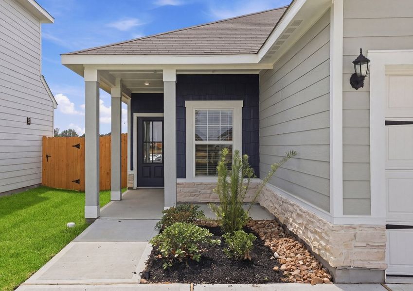 Close-up of the covered front entry featuring a stone accent and the front door.