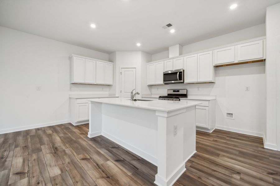 A kitchen with white cabinets. A kitchen with white cabinets.