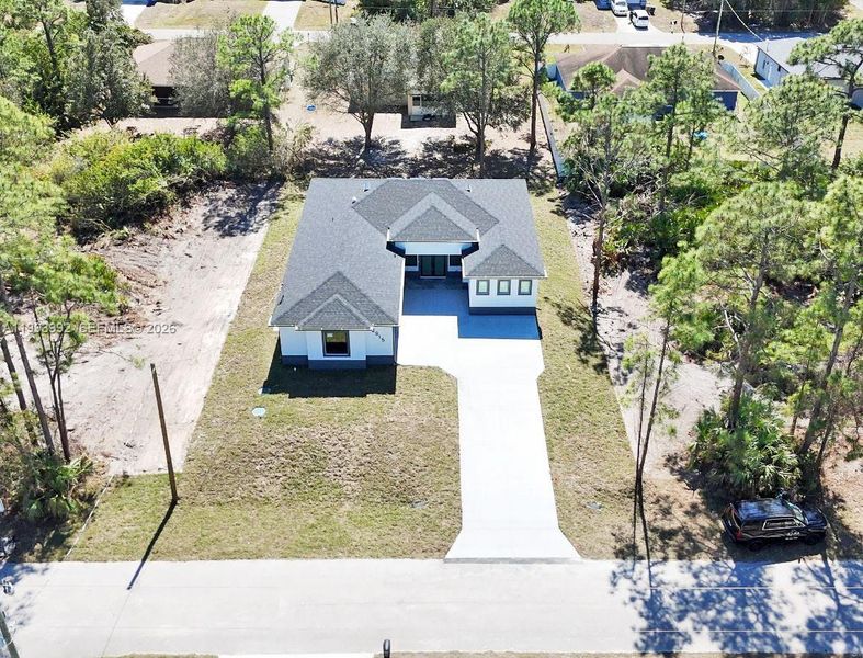 Front exterior of a new home in , Lehigh Acres, FL, highlighting curb appeal (Image 27).