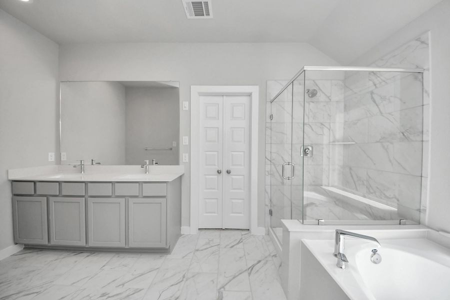 Escape to a spa-like oasis in this primary bathroom. Enjoy a walk-in shower with tile surround, a separate garden tub with custom detailing, and an elegant vanity featuring light countertops, modern hardware, and beautiful recessed lights. Experience luxury and relaxation in every detail. Sample photo of completed home with similar floor plan. Actual colors and selections may vary. Escape to a spa-like oasis in this primary bathroom. Enjoy a walk-in shower with tile surround, a separate garden tub with custom detailing, and an elegant vanity featuring light countertops, modern hardware, and beautiful recessed lights. Experience luxury and relaxation in every detail. Sample photo of completed home with similar floor plan. Actual colors and selections may vary.