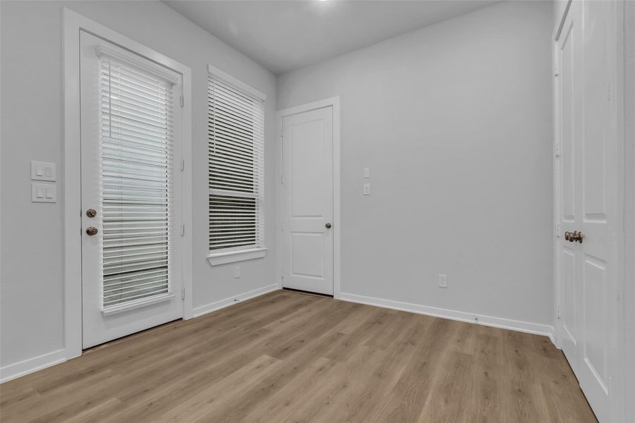 Dining room with a window and a door to the patio.