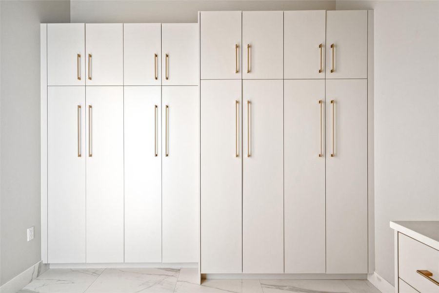 Spacious  Storage Solution with Elegant Cabinetry in the Laundry room.