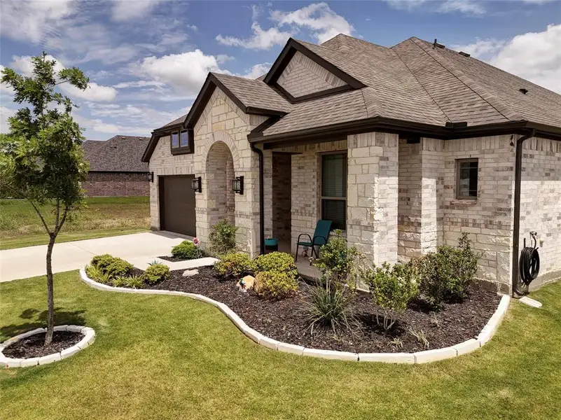 Front exterior of a new home in , Venus, TX, highlighting curb appeal (Image 24).