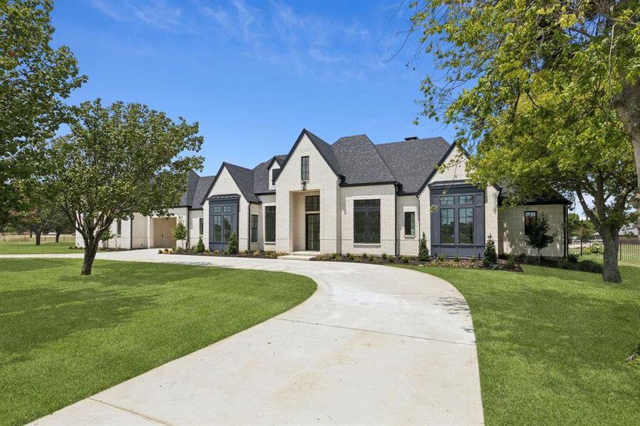 Professionally landscaped and wired for 8 security cameras, exterior internet, speakers, decorative or Christmas lighting, and porte cochere electric gate.