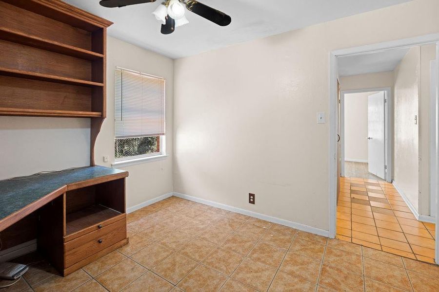 Office featuring light tile patterned floors and ceiling fan