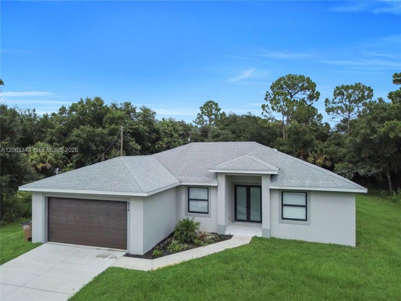 Front exterior of a new home in , Lehigh Acres, FL, highlighting curb appeal (Image 2). Front exterior of a new home in , Lehigh Acres, FL, highlighting curb appeal (Image 2).