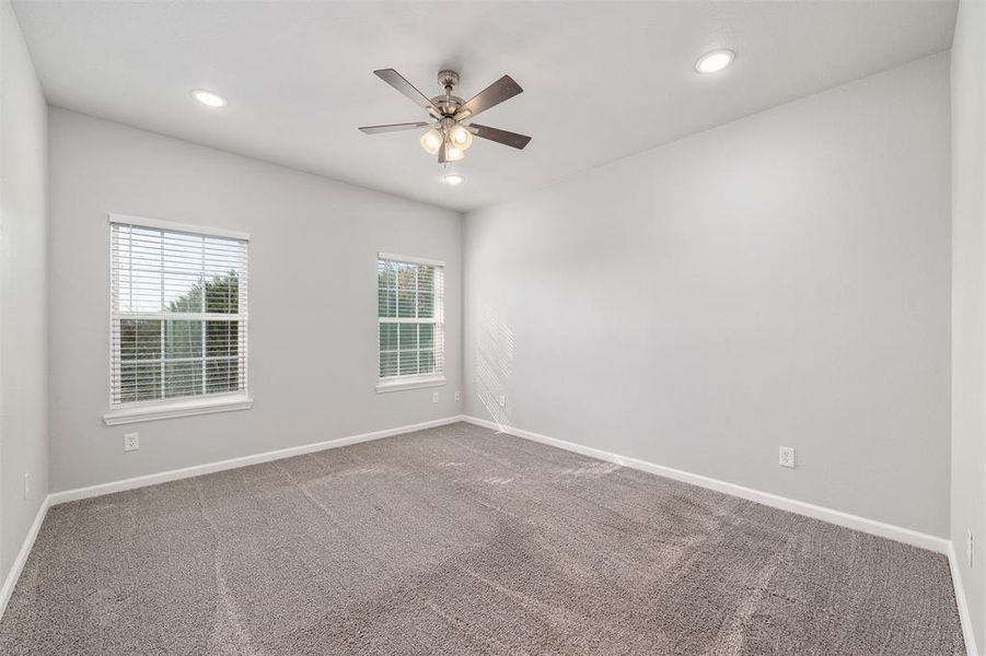 Spare room with carpet floors and ceiling fan