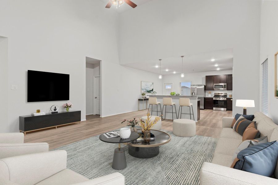The virtually staged family room offers a different perspective of this open-concept space, showcasing the smooth flow between the living area, dining space, and kitchen. It’s an ideal setting for family gatherings and everyday comfort.  Down the hallway you will discover the Primary Suite tucked away for privacy!