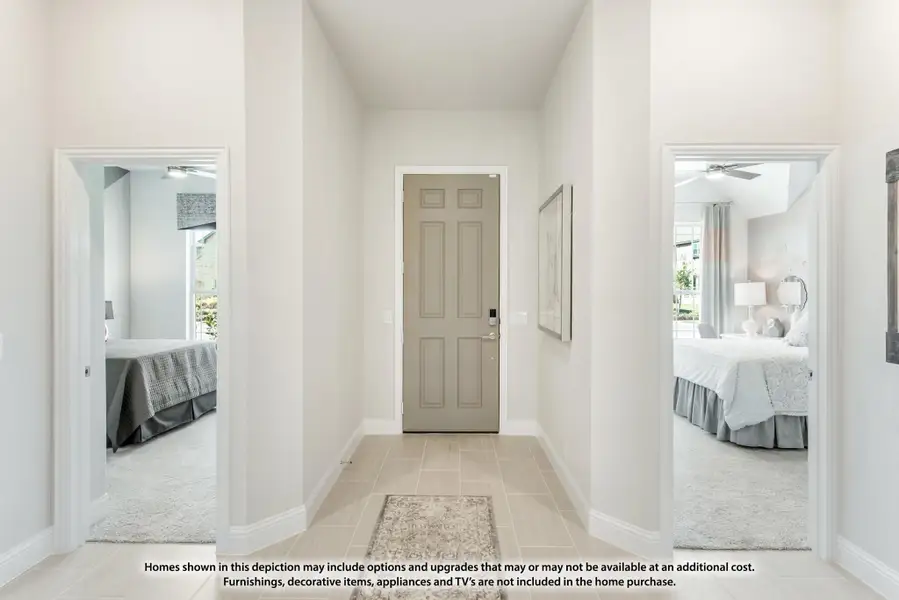 Bright hallway with tile floors and two bedroom doorways on each side leading to a gray entry door Bright hallway with tile floors and two bedroom doorways on each side leading to a gray entry door