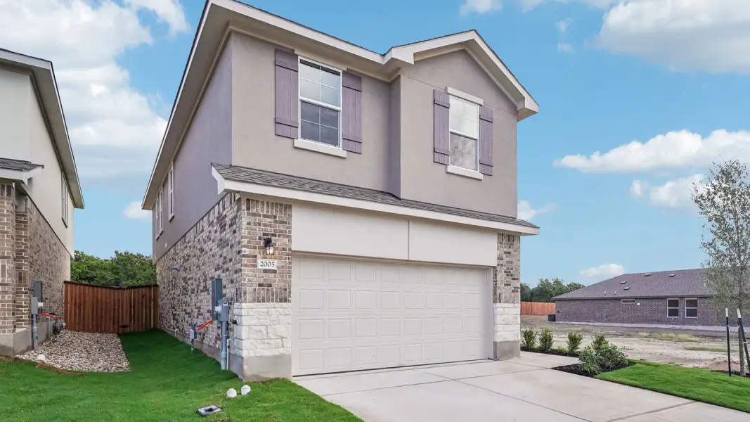 Front exterior of a new home in Bar W Ranch, Leander, TX, highlighting curb appeal (Image 18).