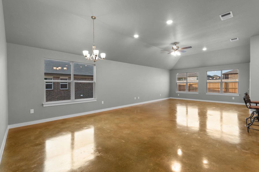 A spacious common area boasts lofty vaulted ceilings and polished concrete floors.