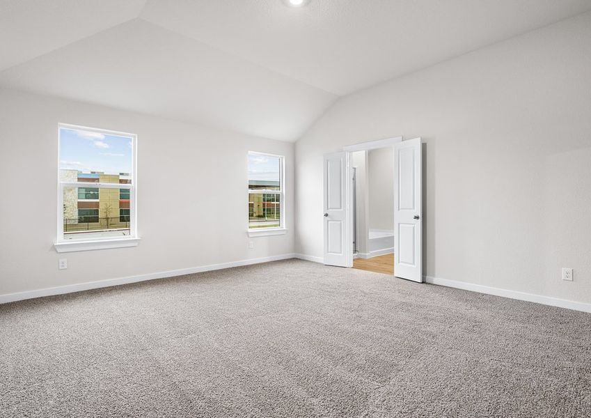 The master bedroom is spacious and has two large windows.