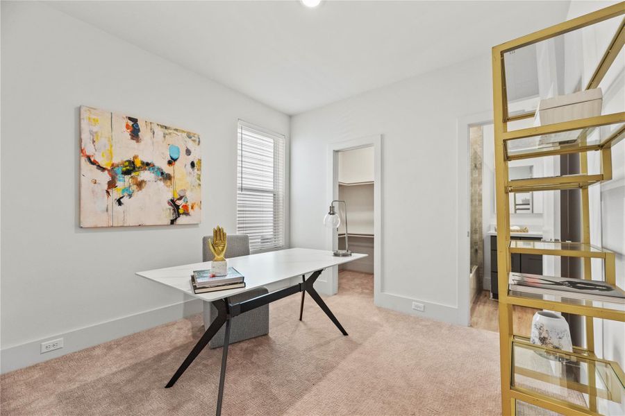 Bright and modern, this secondary bedroom features soft neutral carpet, clean white walls, and large windows that fill the space with natural light.