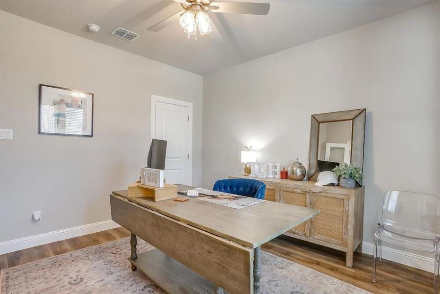 Office with ceiling fan and light hardwood / wood-style flooring