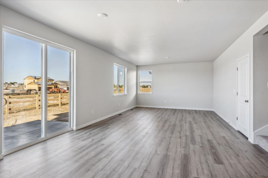 A room with a wood floor and glass doors. A room with a wood floor and glass doors.