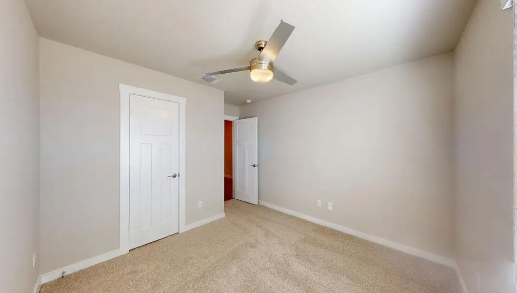 Unfurnished bedroom with carpet floors, a ceiling fan, and a closet
