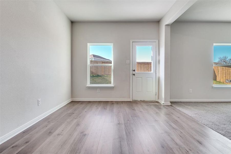 Foyer featuring baseboards and light wood-style floors