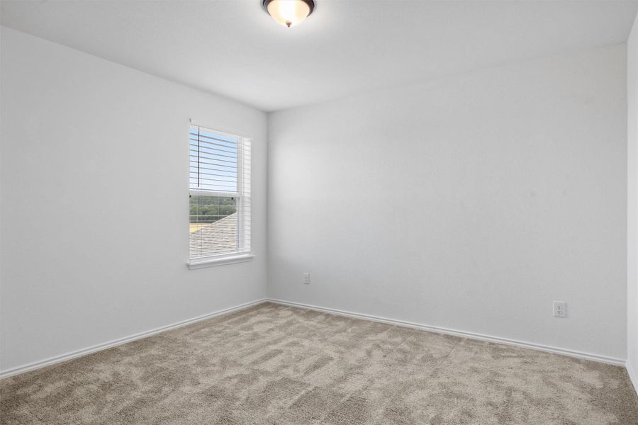 Empty room featuring carpet and baseboards