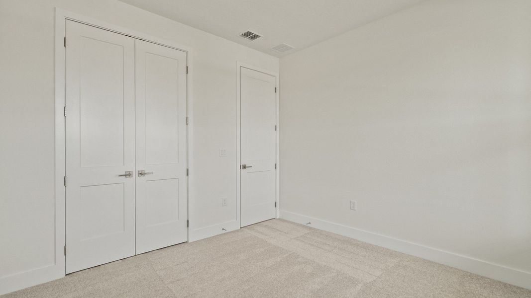 The third bedroom with a spacious closet of the Buttonwood by DRB Homes at Trailside in Mount Dora, FL.
