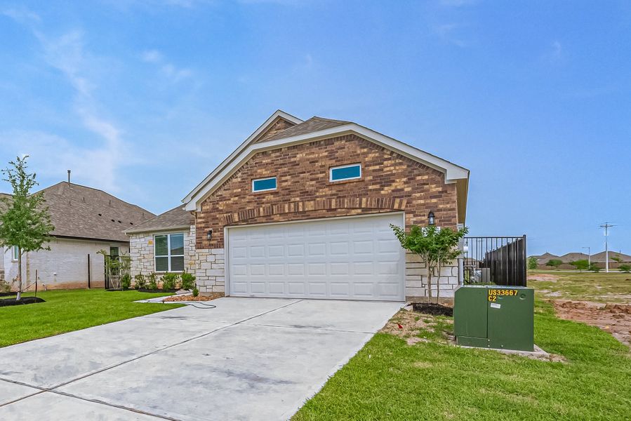 Representative exterior photo of a completed home built from the Floor Plan 2620 by Colina Homes in Woodland Lakes, Huffman, TX (Image 24). Representative exterior photo of a completed home built from the Floor Plan 2620 by Colina Homes in Woodland Lakes, Huffman, TX (Image 24).