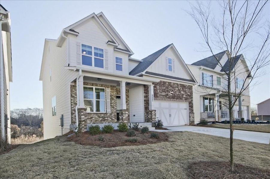 Front exterior of a new home in Clark Farms, Flowery Branch, GA, highlighting curb appeal (Image 2). Front exterior of a new home in Clark Farms, Flowery Branch, GA, highlighting curb appeal (Image 2).