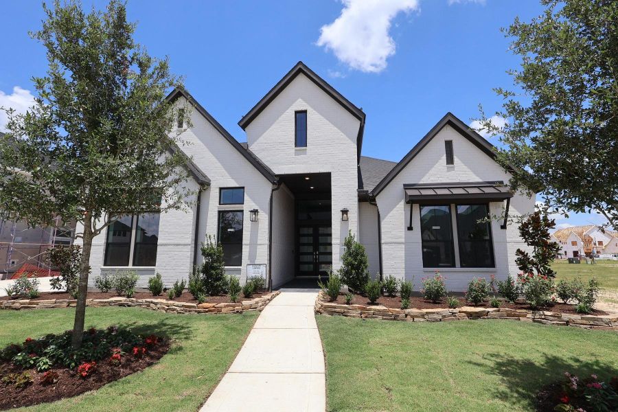 Front exterior of a new home in Dunham Pointe, Cypress, TX, highlighting curb appeal (Image 2). Front exterior of a new home in Dunham Pointe, Cypress, TX, highlighting curb appeal (Image 2).