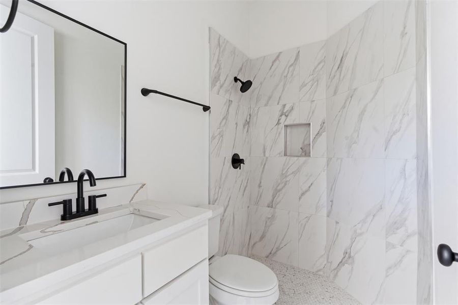 Full bath with vanity and a marble finish shower Full bath with vanity and a marble finish shower