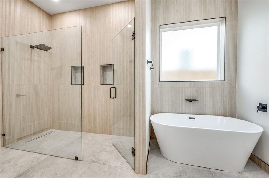 Full bath featuring a freestanding tub and a shower stall
