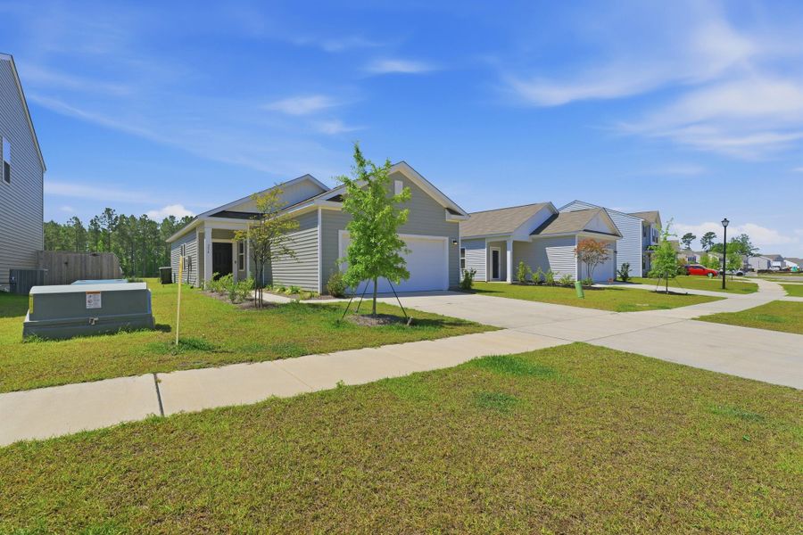 Front exterior of a new home in Pender Woods at Cane Bay, Summerville, SC, highlighting curb appeal (Image 2). Front exterior of a new home in Pender Woods at Cane Bay, Summerville, SC, highlighting curb appeal (Image 2).