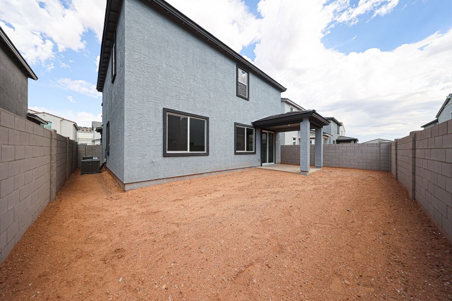 A dirt road between two buildings.