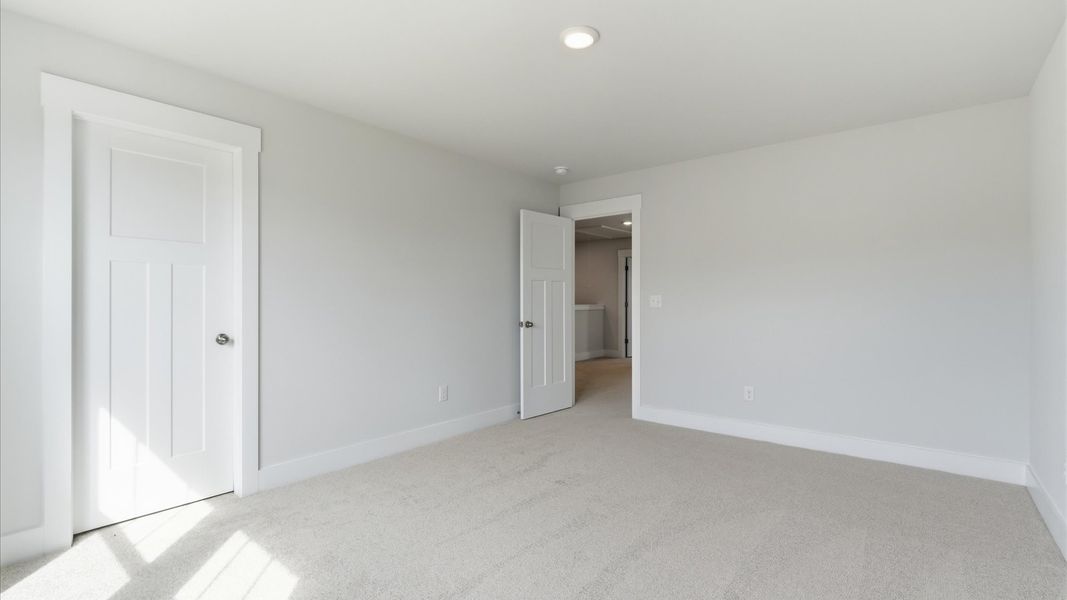 First-class secondary bedroom with comfortable carpeted flooring and generous closet space at this home in Gray Court, SC